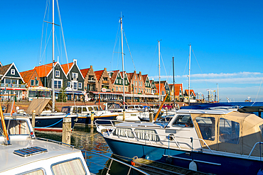 Volendam marina with boats and traditional Dutch buildings in the background, Volendam, North Holland, The Netherlands, Europe