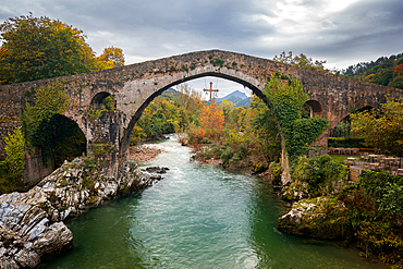 Cangas de Onis historic medieval Roman bridge over the Sella River in Picos de Europa National Park, Asturias, Spain, Europe