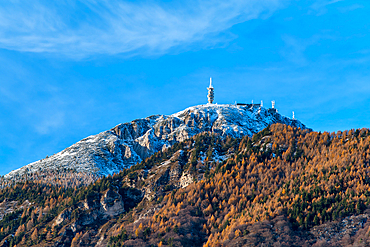 Palon mountain top covered in snow in an autumn landscape with yellow and brown color trees, Garniga Terme, Trentino, Italy, Europe