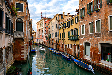 Venice canal with traditional gondola boats and colorful houses at sunset, Venice, UNESCO World Heritage Site, Veneto, Italy, Europe