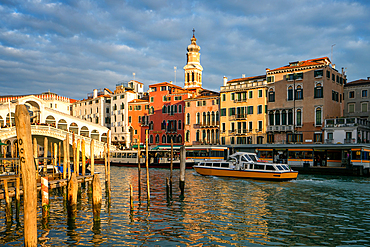 View of colorful houses, Rialto bridge and Grand Canal with boats at sunset, Venice, UNESCO World Heritage Site, Veneto, Italy, Europe