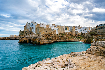 Polignano a Mare historic coastal city with traditional houses on the adriatic sea cliffs with turquoise water, in Italy