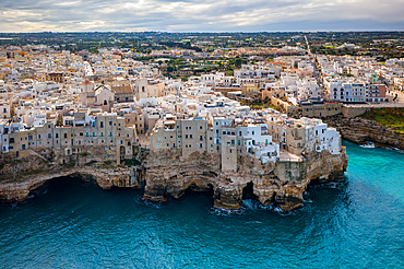 Polignano a Mare drone aerial view of historic city on the cliffs of adriatic sea with turquoise water, in Italy