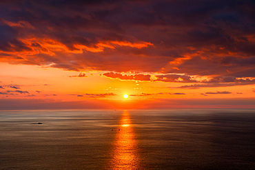 Sunset on the sea with two boats crossing the sunset reflection on the sea