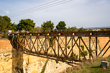 Metalic bridge crossing Corinth artificial canal in Greece that connects the Gulf of Corinth in the Ionian Sea with the Saronic Gulf in the Aegean Sea