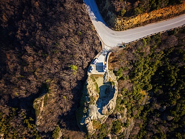 Drone aerial view of camper vans with solar panels on the roof, parked on a wild spot on the mountains in autumn, Kalabaka, Greece