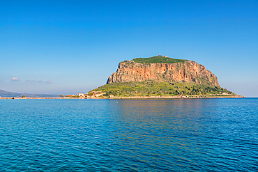 Monemvasia historic city on an island with a mountain in the middle of turquoise sea water, in Greece