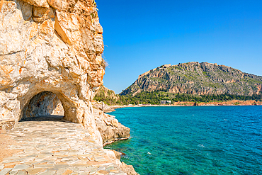 Arvanitias beach in historic city of Nafplion with Palamidi fortress on top of the mountain in Greece