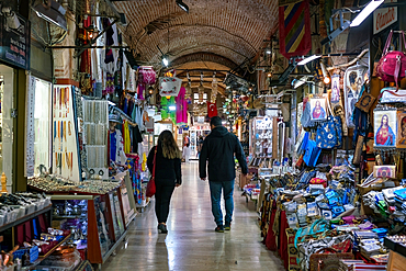 Street inside Izmir Kemeralti bazaar market full with souvenir shops in Turkey