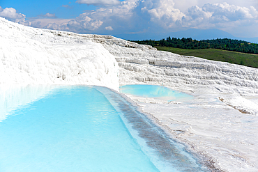 Pamukkale calcium carbonate white travertines with turquoise water in Turkey