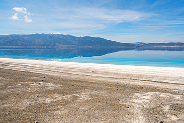 Salda lake with turquoise water and white sand and mountains at sunset in Turkey