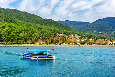 Tourist boa in the turquoise water of Ekincik in Turkey