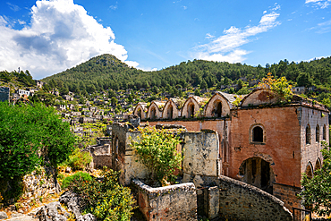 Kayakoy greek ghost town church and abandoned houses in the mountains full of vegetations in Fethiye, Turkey