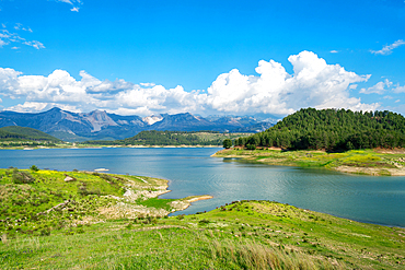 Karacaoren dam lake with turquoise water, trees and mountains on the background on a sunny day in Turkey