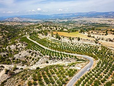 Drone view of a curvy road on a dry landscape in the mountains of Turkey in Antalya province