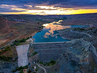 Drone aerial view of Akkoy dam lake with reflection on the water in Cappadocia at sunset, in Turkey