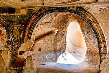 Interior of a catholic cave church carved inside a rock formation in Red and Rose valley in Cappadocia, Turkey