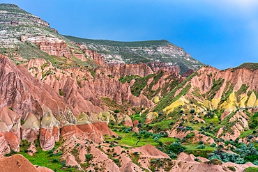 Red and rose valley landscape with colorful rock formations in Cappadocia, Turkey