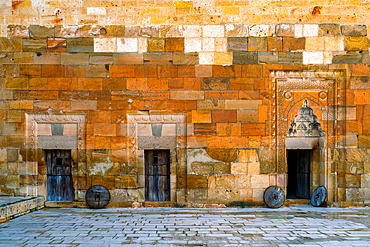 Wooden doors with beautiful stone frame adornments in Saruhan Caravanserai medieval lodge in Cappadocia, Turkey