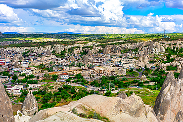 Goreme town in Cappadocia Turkey with Rocket Valley rock formations on the background
