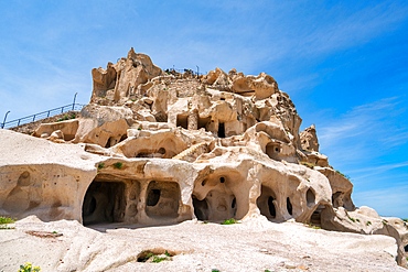 Uchisar town castle with caves inside a rock formation in Cappadocia, Turkey