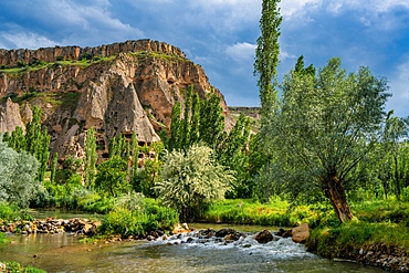 Selime houses carved on the rocks by the river on the Ihlara valley in Cappadocia, Turkey