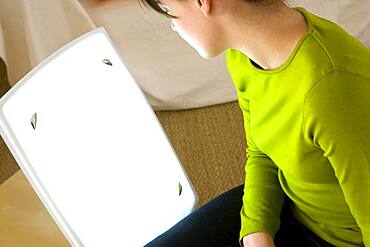 Light therapy lamps emit white light imitating daylight. They are used, between among other things, to fight against seasonal affective disorder.