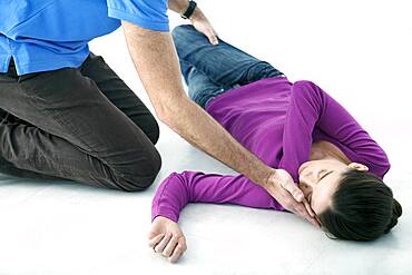 First aid techniques : placing the victim in the recovery position. Step 3 : catch hold of the leg furthest away from you behind the knee, lift it up keeping the foot on the ground. Turn the victim towards you.