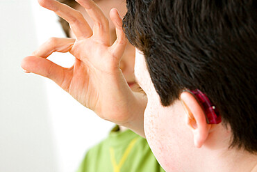 Do not use for HIV. Young boy using the French sign language to discuss with his hearing-impaired brother