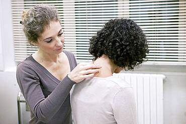 Doctor examining patient's neck.