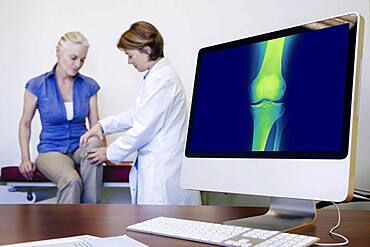 Doctor examining patient's knee.