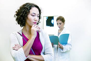 Doctor explaining to a patient the result of her mammogram.