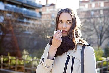 Woman applying lip balm.