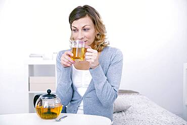 Woman drinking herbal tea.