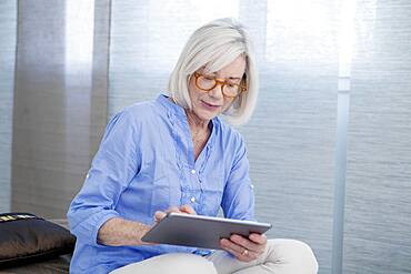 Senior woman using tablet computer.