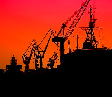 Silhouette of sea port cranes in the morning, St. Petersburg, Russia.