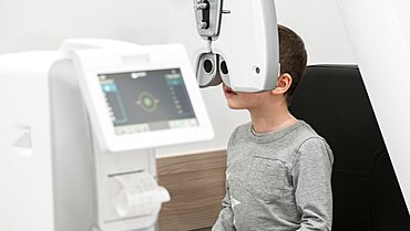 The boy is the patient on reception at doctor ophthalmologist. Diagnostic ophthalmologic equipment. Medicine concept.