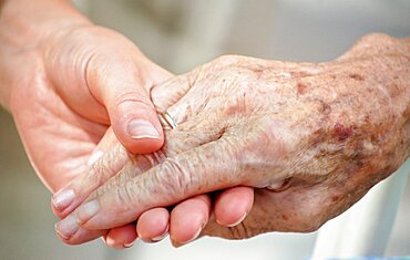 Woman gives her Grandma her Hand.