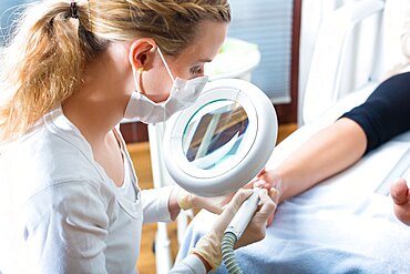 Woman receiving podiatry treatment in Day Spa.