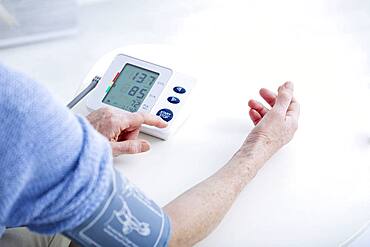 Senior woman measuring her blood pressure.