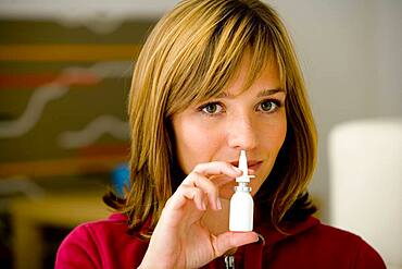 Woman using nose spray