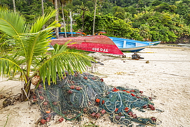 Fishing net and boats on the beach at Maracas Bay, Trinidad island, Trinidad and Tobago.