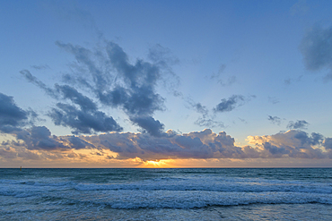 Caribbean Sea sunrise from the beach at Grand Residences Riviera Cancun, Puerto Morelos, Riviera Maya, Mexico.