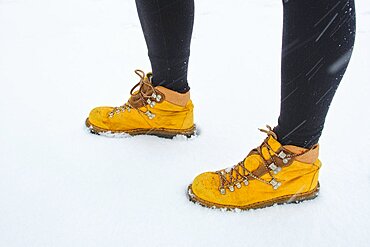 Caucasian young woman enjoying snow outdoor in winter time. Navarre, Spain, Europe.