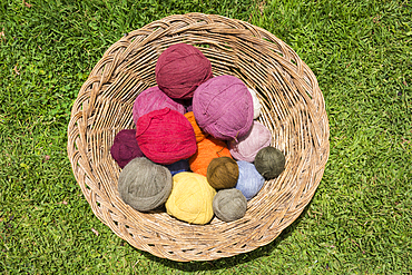 Basket of naturally dyed alpaca yarn for weaving cloth in Misminay Village, Sacred Valley, Peru.