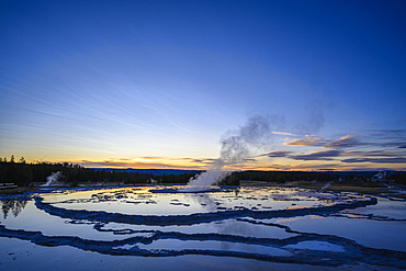 Great Fountain Geyser at sunset; Firehole Lake Drive, Yellowstone National Park, Wyoming, USA.