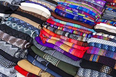 Woven cloth fabric of traditional Quechua design for sale by roadside vendor in Sacred Valley, Peru.