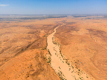 A river bed, palms, and dunes surround the village of Kamour, Mauritania, Sahara Desert, West Africa, Africa