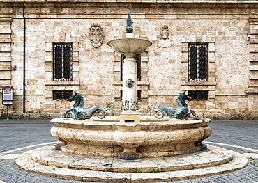 Public drinking water fountain with bronze seahorses on the Piazza Arringo, Ascoli Piceno, Marche, Italy