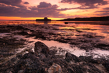 St. Cwyfan's Church on the island of Cribinau at sunset, near Aberffraw, Anglesey, North Wales, United Kingdom, Europe